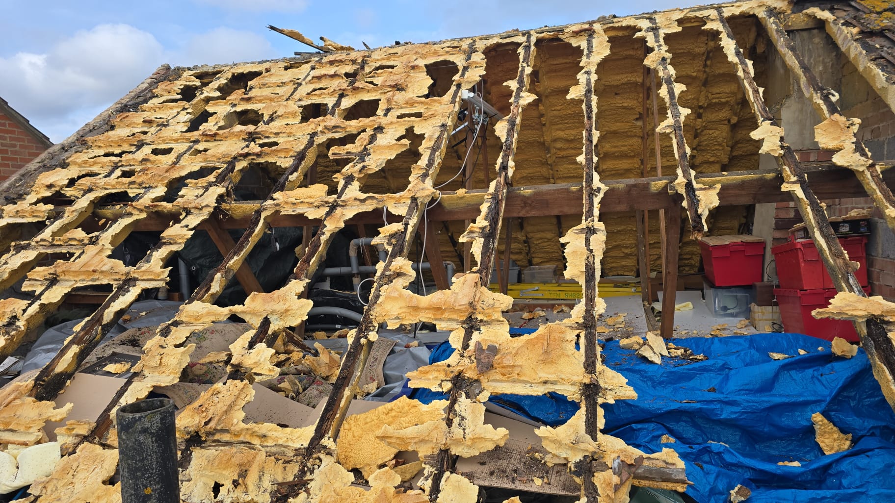 A full pitch stripped back — decayed timbers visible where the foam was removed.